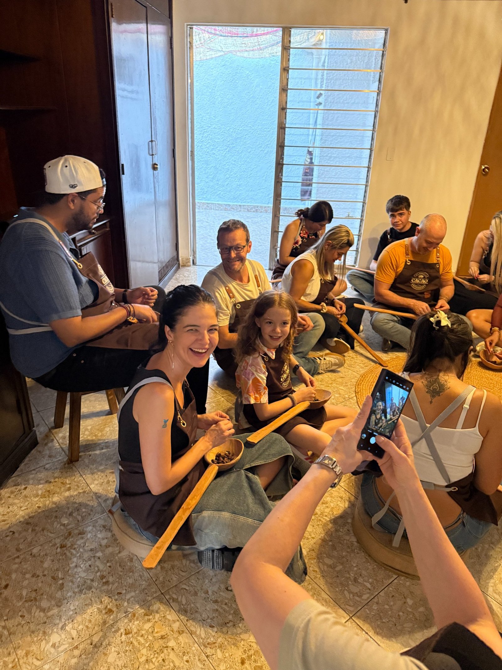A group of people participate in a traditional chocolate making workshop in Mexico.